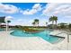 Community pool featuring shallow wading area, seating, sunshades, island, and palm trees at 31779 Asbury Ave, Wesley Chapel, FL 33545