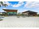 Resort-style pool area with lounge chairs, umbrellas, and modern architectural features under a bright, sunny sky at 31779 Asbury Ave, Wesley Chapel, FL 33545
