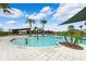 Community pool featuring a shallow wading area with water features, seating and covered lounge area at 31779 Asbury Ave, Wesley Chapel, FL 33545