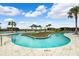 Community pool featuring a lazy river, shallow wading area, seating, sunshades, island, and palm trees at 31779 Asbury Ave, Wesley Chapel, FL 33545