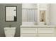 Bright bathroom features a white vanity with marble countertop, framed art, and classic subway tile at 32122 Griffin Sands Ln, San Antonio, FL 33576