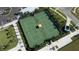 Overhead view of tennis courts surrounded by sidewalks and mature landscaping at 32122 Griffin Sands Ln, San Antonio, FL 33576