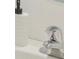 Close-up of a bathroom vanity featuring a white countertop, chrome faucet, and decorative soap dispenser adding elegance to the space at 32730 Winterwood Boulevard Blvd, Wesley Chapel, FL 33543