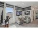 Comfortable bonus room with gray walls, movie decor, and a cozy gray couch and ottoman for relaxing entertainment at 32730 Winterwood Boulevard Blvd, Wesley Chapel, FL 33543