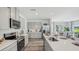 Modern kitchen features stainless steel appliances, ample counter space, and a center island at 32730 Winterwood Boulevard Blvd, Wesley Chapel, FL 33543