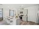 Contemporary kitchen with gray cabinetry, stainless steel appliances, a central island with bar seating, and wood-look floors at 32730 Winterwood Boulevard Blvd, Wesley Chapel, FL 33543