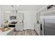 Modern kitchen featuring stainless steel appliances, gray cabinetry, and wood-look flooring, offering a contemporary cooking space at 32730 Winterwood Boulevard Blvd, Wesley Chapel, FL 33543