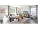 Cozy living room with a white sofa, a wooden coffee table, and a large window overlooking the yard at 32730 Winterwood Boulevard Blvd, Wesley Chapel, FL 33543