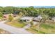 Aerial view of home with metal roof, sheds, covered parking, fenced yard, driveway, and road at 3407 Cason Rd, Plant City, FL 33566