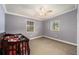 This is another bedroom with two windows and neutral-colored walls and carpet at 3407 Cason Rd, Plant City, FL 33566