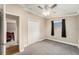 Neutral bedroom featuring a ceiling fan, closet, and window with gray carpet at 3407 Cason Rd, Plant City, FL 33566