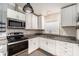 Modern kitchen with white cabinets, granite countertops, and stainless steel appliances at 3407 Cason Rd, Plant City, FL 33566