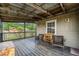 Relax on this covered porch with wood floors and a view of the surrounding nature at 3407 Cason Rd, Plant City, FL 33566