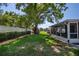 Well-maintained backyard with a large tree providing shade, and a screened-in patio for outdoor living at 3408 90Th N Ter, Pinellas Park, FL 33782