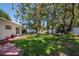 Expansive backyard with mature trees and a manicured lawn, ideal for recreation and relaxation at 3408 90Th N Ter, Pinellas Park, FL 33782
