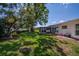 Large backyard with a screened-in patio, mature trees, and a well-kept lawn, perfect for outdoor activities at 3408 90Th N Ter, Pinellas Park, FL 33782