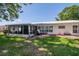 Spacious backyard featuring a screened-in patio and lush green lawn, perfect for outdoor enjoyment at 3408 90Th N Ter, Pinellas Park, FL 33782