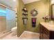 Bathroom featuring earth tone paint, a walk-in shower, and dark wood cabinetry at 3408 90Th N Ter, Pinellas Park, FL 33782