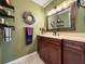 Comfortable bathroom with neutral paint, a large framed mirror, and a spacious countertop and sink at 3408 90Th N Ter, Pinellas Park, FL 33782
