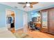 Cozy bedroom featuring a light blue wall, a ceiling fan, and a closet at 3408 90Th N Ter, Pinellas Park, FL 33782