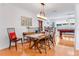 Open-concept dining area with hardwood floors, modern lighting, and access to a billiards room at 3408 90Th N Ter, Pinellas Park, FL 33782