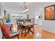 Dining room featuring wood floors, white walls, and a view into the kitchen and game room at 3408 90Th N Ter, Pinellas Park, FL 33782