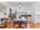 Dining room features wooden floors, white walls, and views into the game room and kitchen at 3408 90Th N Ter, Pinellas Park, FL 33782