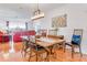 Elegant dining area featuring hardwood floors, a modern chandelier, and views to the living room at 3408 90Th N Ter, Pinellas Park, FL 33782
