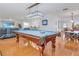 Bright game room featuring a pool table, with an overhead light fixture and hardwood flooring at 3408 90Th N Ter, Pinellas Park, FL 33782