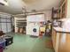 Functional garage space with laundry area, storage cabinets, and ample room for parking at 3408 90Th N Ter, Pinellas Park, FL 33782