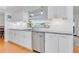 Kitchen featuring stainless steel dishwasher, granite countertops and white cabinetry at 3408 90Th N Ter, Pinellas Park, FL 33782