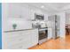 Kitchen with stainless steel appliances, updated cabinets, granite countertops and wood flooring at 3408 90Th N Ter, Pinellas Park, FL 33782