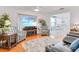 Inviting living room featuring comfortable seating, hardwood flooring, and a serene view of the outdoors at 3408 90Th N Ter, Pinellas Park, FL 33782