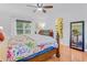 Comfortable bedroom with plush bedding, ceiling fan, and a window overlooking the well-maintained yard at 3408 90Th N Ter, Pinellas Park, FL 33782