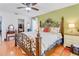 Spacious main bedroom with a decorative bedframe, ceiling fan, and ensuite bathroom and closet access at 3408 90Th N Ter, Pinellas Park, FL 33782