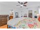 Sunlit bedroom featuring a bed with floral patterned bedding and access to a walk-in closet and bathroom at 3408 90Th N Ter, Pinellas Park, FL 33782