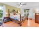 Bright main bedroom with hardwood floors, ceiling fan, and a large window for ample natural light at 3408 90Th N Ter, Pinellas Park, FL 33782
