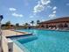 Community pool with lounge chairs surrounding the blue water at 3408 90Th N Ter, Pinellas Park, FL 33782