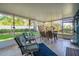 Inviting sunroom with tile floors, comfortable seating, and a serene view of the landscaped backyard at 3408 90Th N Ter, Pinellas Park, FL 33782