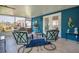 Charming sunroom with bright blue walls, tile floors, and cozy seating for relaxing and entertaining at 3408 90Th N Ter, Pinellas Park, FL 33782