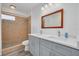 Bathroom featuring a double vanity, a walk-in shower, and tiled walls at 3516 Casablanca Ave, St Pete Beach, FL 33706