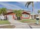 Charming single-story home with a well-maintained lawn, driveway, and tropical palm trees at 3516 Casablanca Ave, St Pete Beach, FL 33706