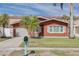 Charming single-story home with red exterior, garage, and a well-maintained front lawn with a mailbox at 3516 Casablanca Ave, St Pete Beach, FL 33706