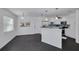 Bright kitchen and dining area, showcasing modern white cabinets and stainless steel appliances at 3516 Casablanca Ave, St Pete Beach, FL 33706