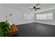 Open living space with dark flooring, a comfortable couch, and large windows for plenty of sunlight at 3516 Casablanca Ave, St Pete Beach, FL 33706