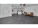 Open-concept living space connects the living room and kitchen with dark floors and modern fixtures at 3516 Casablanca Ave, St Pete Beach, FL 33706