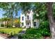 Charming two-story home with a balcony, landscaping, and a well-manicured lawn at 3601 W San Juan St, Tampa, FL 33629