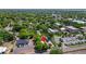 Drone view shows the property with nearby town buildings, businesses, and lush greenery at 38351 7Th Ave, Zephyrhills, FL 33542