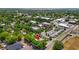 Drone view shows the property with nearby town buildings, businesses, and lush greenery at 38351 7Th Ave, Zephyrhills, FL 33542