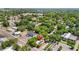 Drone view shows the property with nearby town buildings, businesses, and lush greenery at 38351 7Th Ave, Zephyrhills, FL 33542